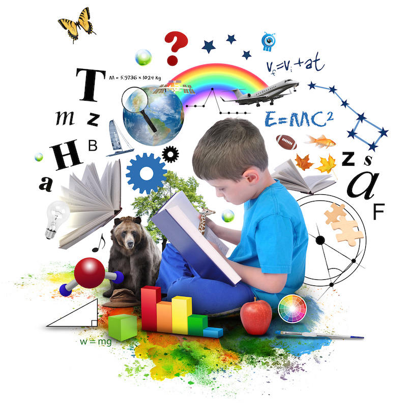 A young boy is reading a book with school icons such as math formulas, animals and nature objects around him for an education concept on white.